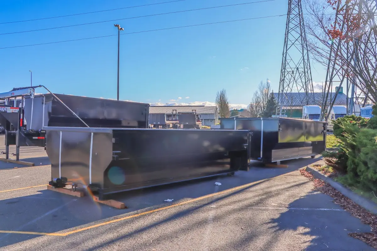 Roll-off dumpster ready for waste disposal at job site for Concrete Dumpster Rental in Montague